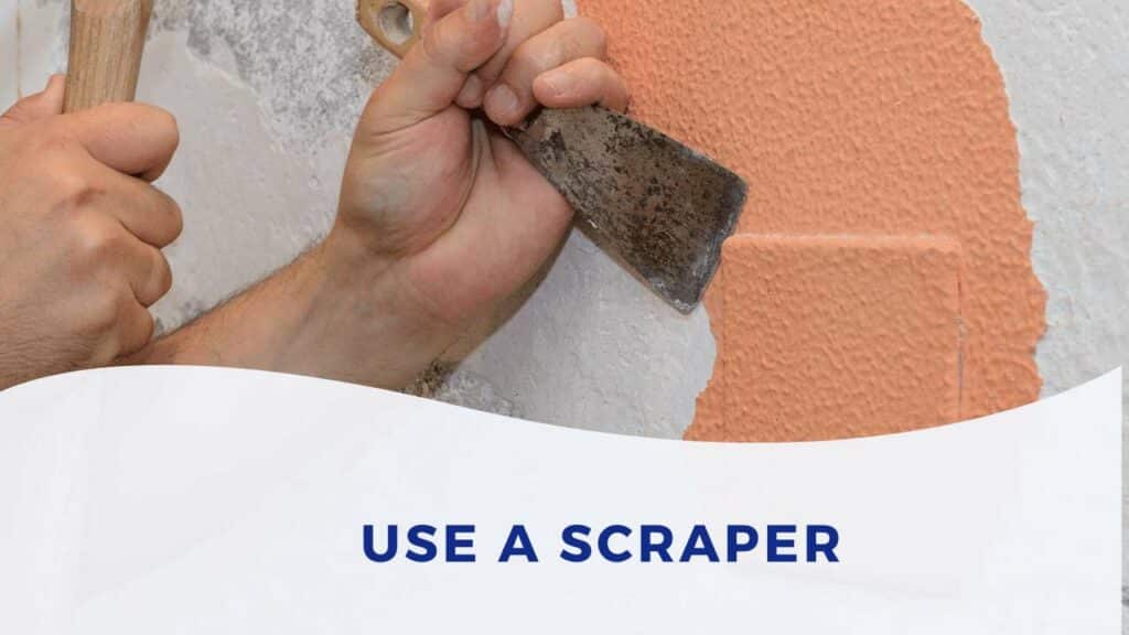 use a paint scraper to remove spray paint drips