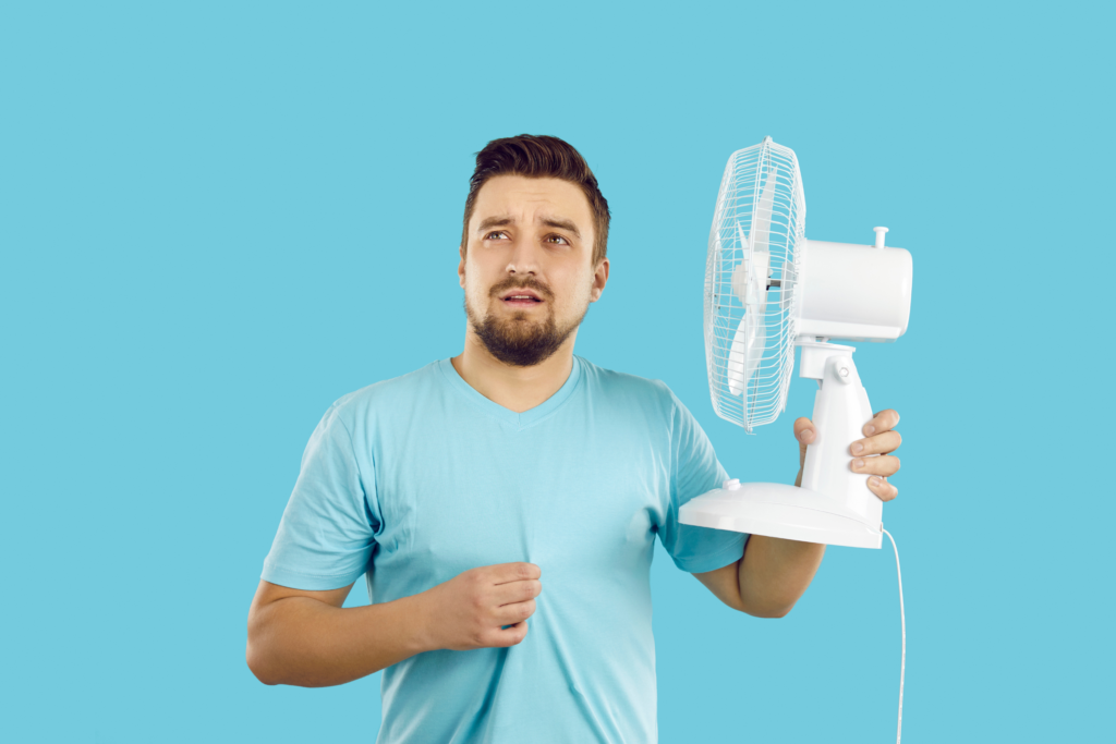 man struggling with heat during the summer