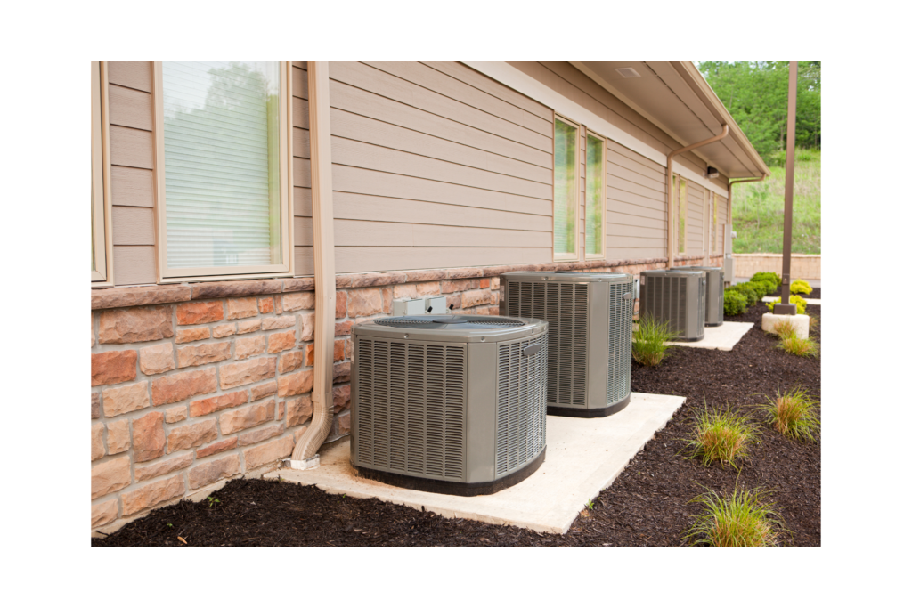 air conditioning units outside of building with landscaping