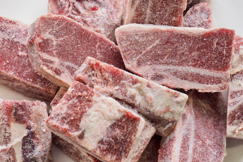 Cuts of frozen red meat with freezer burn.