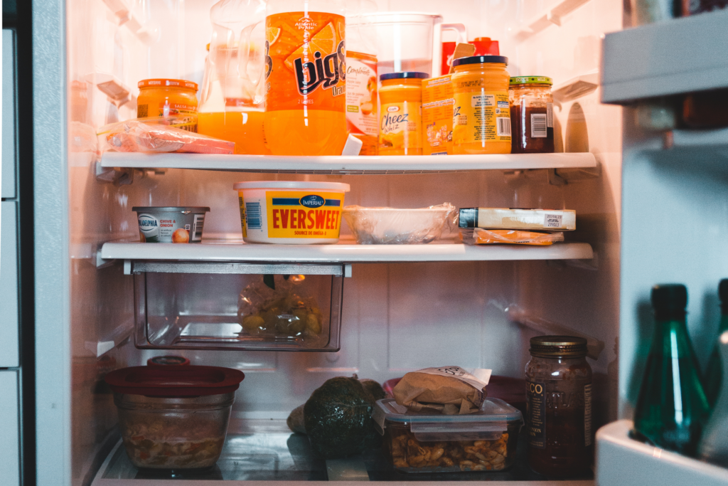 An open fridge full of food and drinks.