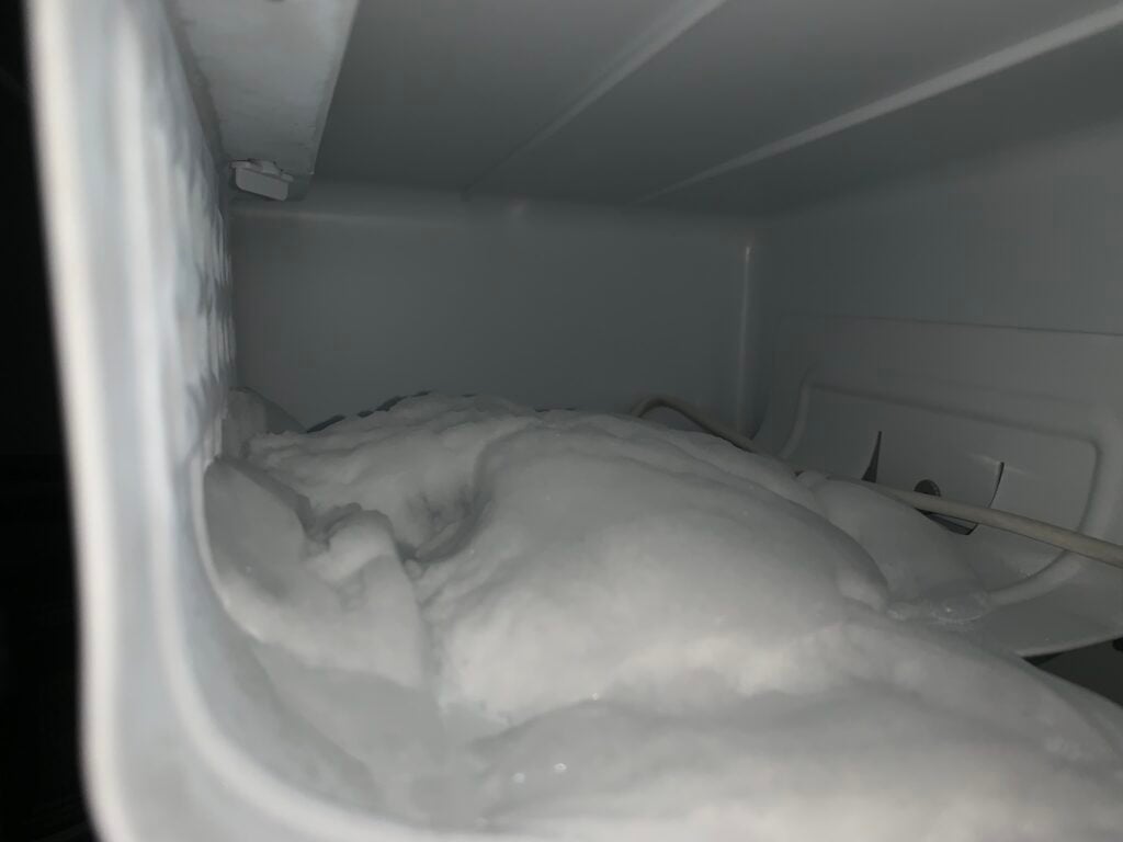 Ice built up inside of a mini fridge.