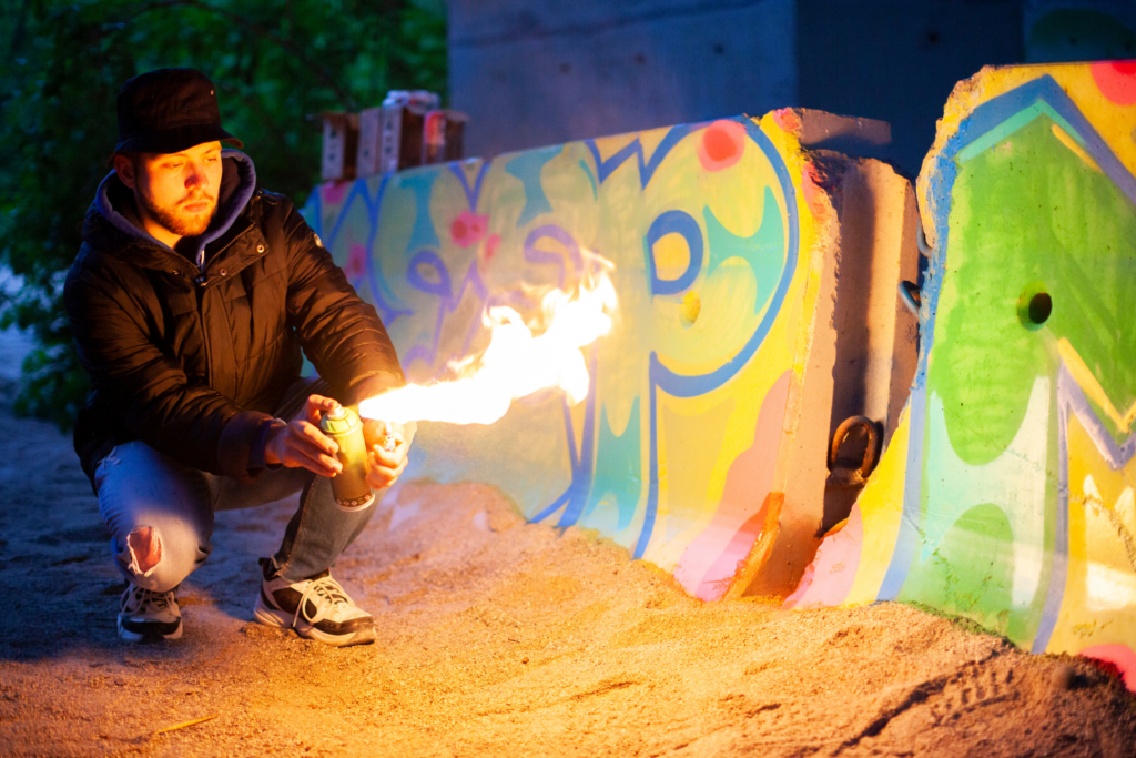 Why do spray paint artists use fire?