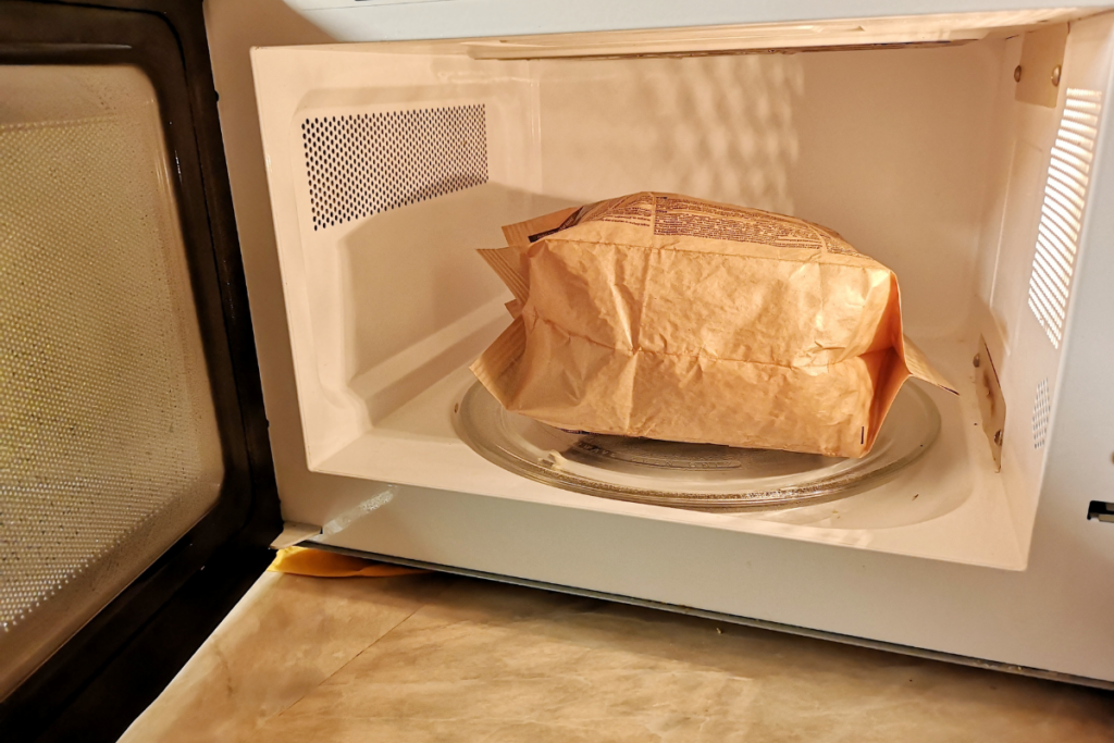 A 700-watt microwave can easily cook a bag of popcorn, but make sure there's enough room for the bag to rotate when it's fully inflated.