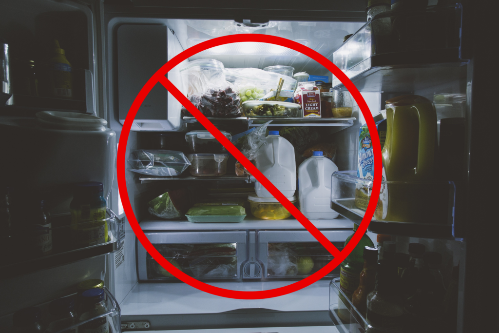 A full fridge with a red "prohibited" sign overlays the image.