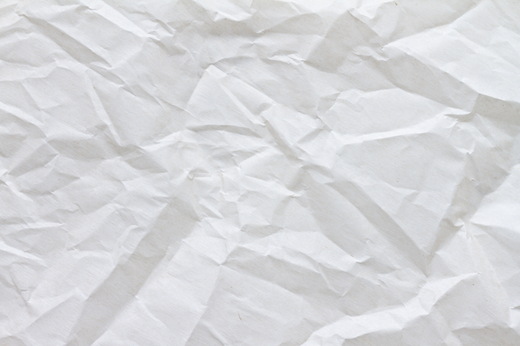 A straight-on photo of crinkled white parchment paper.