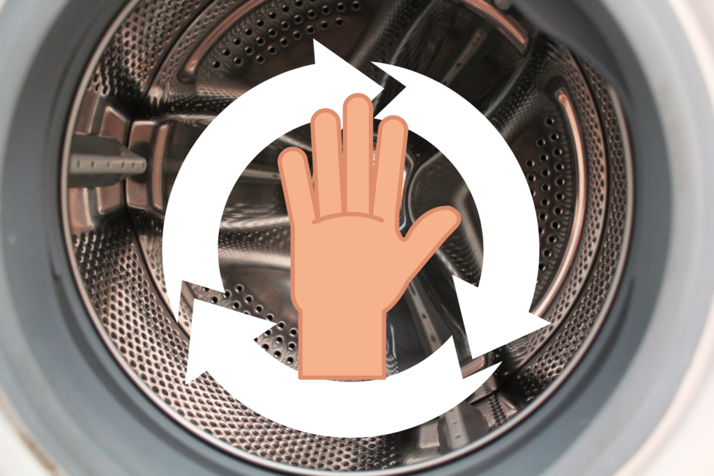 A washing machine drum with an overlaying graphic of a hand and a spinning arrow indicates a person spinning the drum.